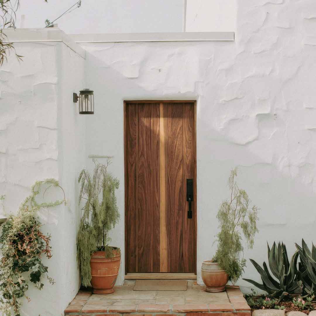 True Plank modern solid walnut wood door panel showcasing natural grain patterns and vertical plank design.